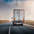 Lorry truck on the highway from behind during sunset