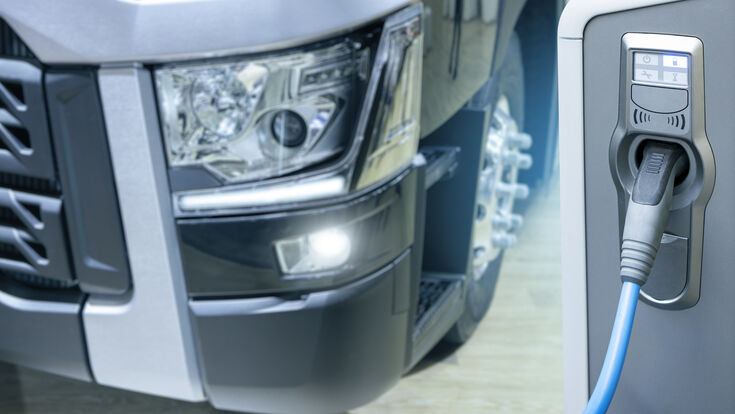 © scharfsinn86 - stock.adobe.com truck electric charging station transportation fleet cargo lorry transport delivery white car vehicle trailer freight shipping industry business logistic trucking big heavy semi clean energy zero emission charge renewable energy power technology socket cable
