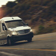 a rent bus is drive by highway