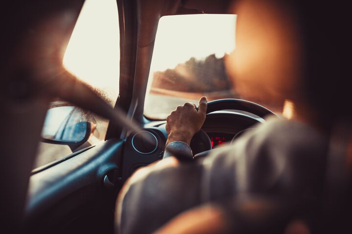 car, driver, driving, vehicle, sunset, man, attention, auto, behind, black, business, caucasian, cruise, dashboard, destinations, hand, human, indoors, inside, journey, motion, motoring, one, people, person, road, seat, speed, steering, traffic, transport, transportation, travel, wheel, male, belt buckle, adult